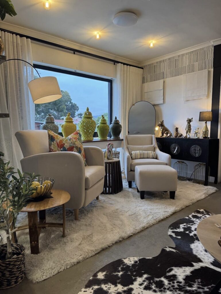 Beige armchairs styled with an arc lamp