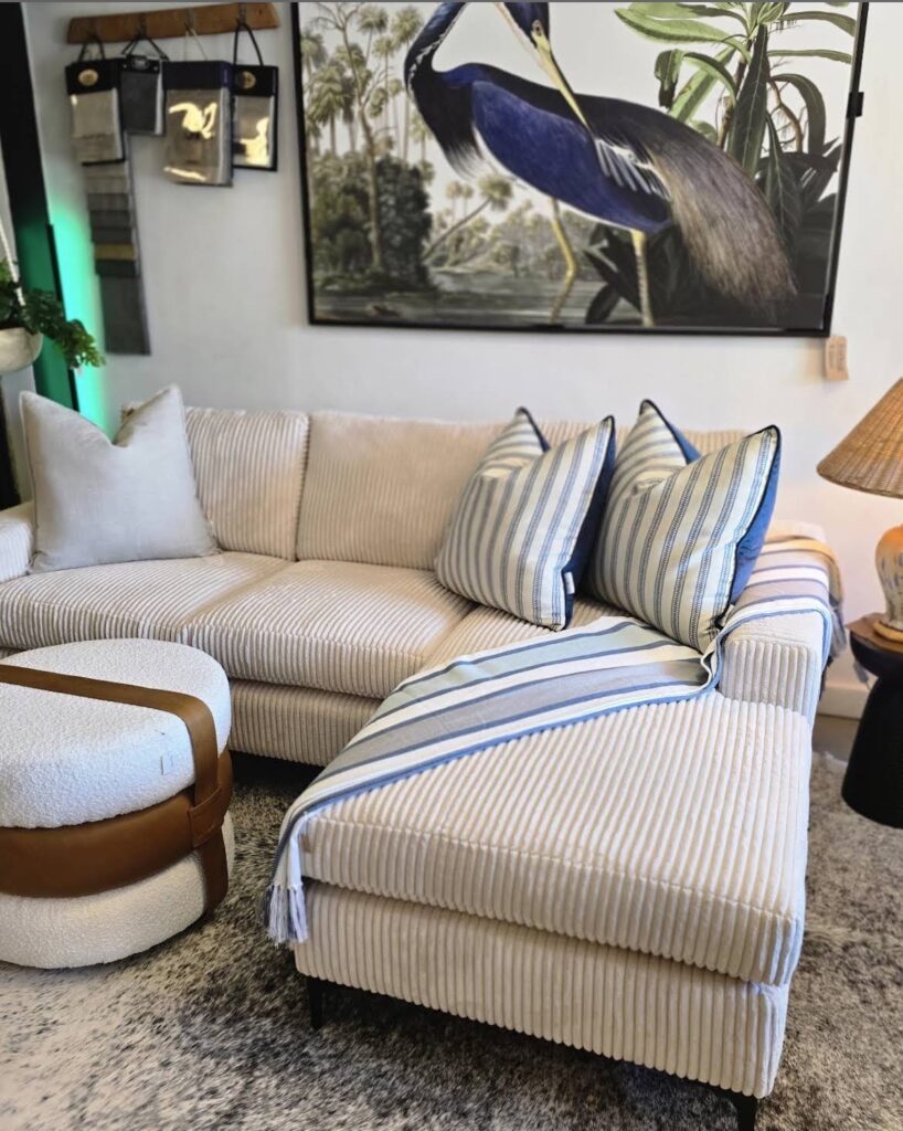 Cream striped sofa styled with a botanical print
