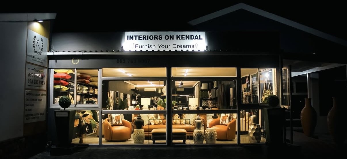 Interiors on Kendal showroom storefront lit up at night
