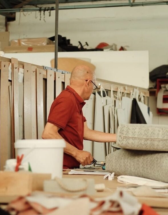 Interiors on Kendal craftsman selecting upholstery fabric rolls in the Cape Town workshop